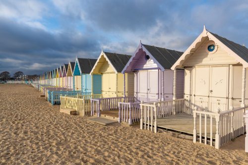 Beach Huts along sandy beach n West Mersea