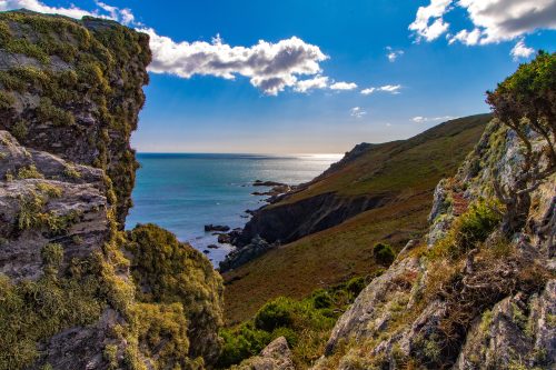Green Hills next to sea with blue sky and cloud
